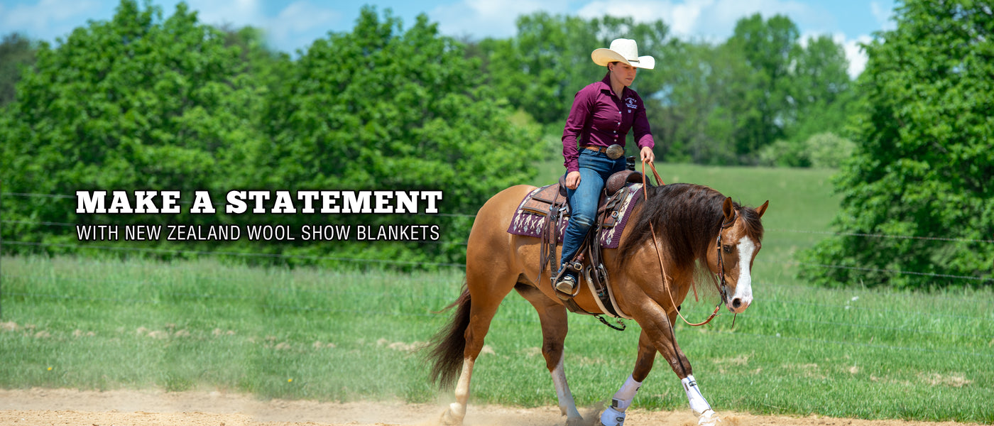 A rider guiding a horse through a field